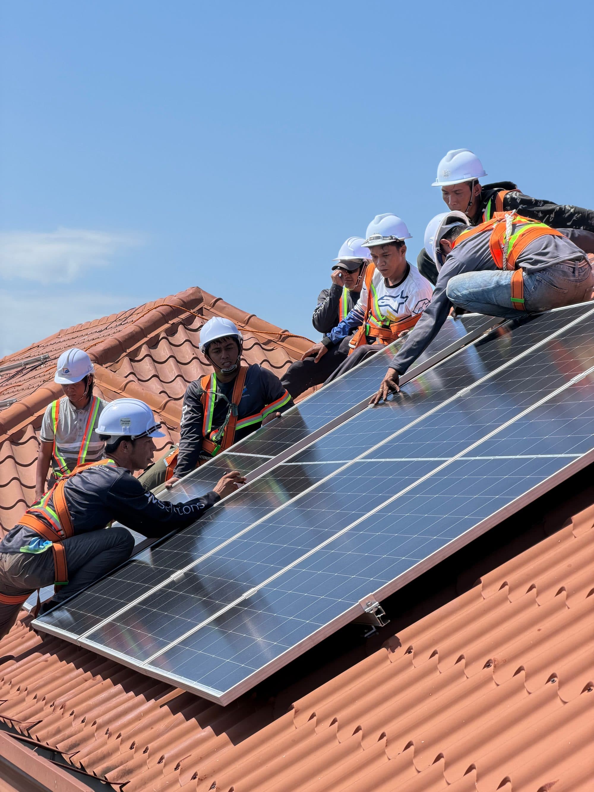 Solar installers on roof installing panels
